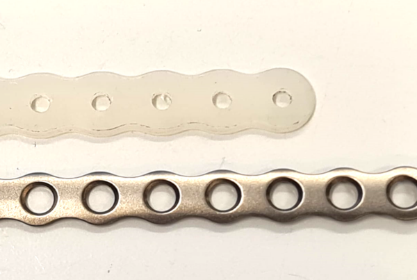 X3 fiber prototype plate and TItanium metacarpal plate, side by side.